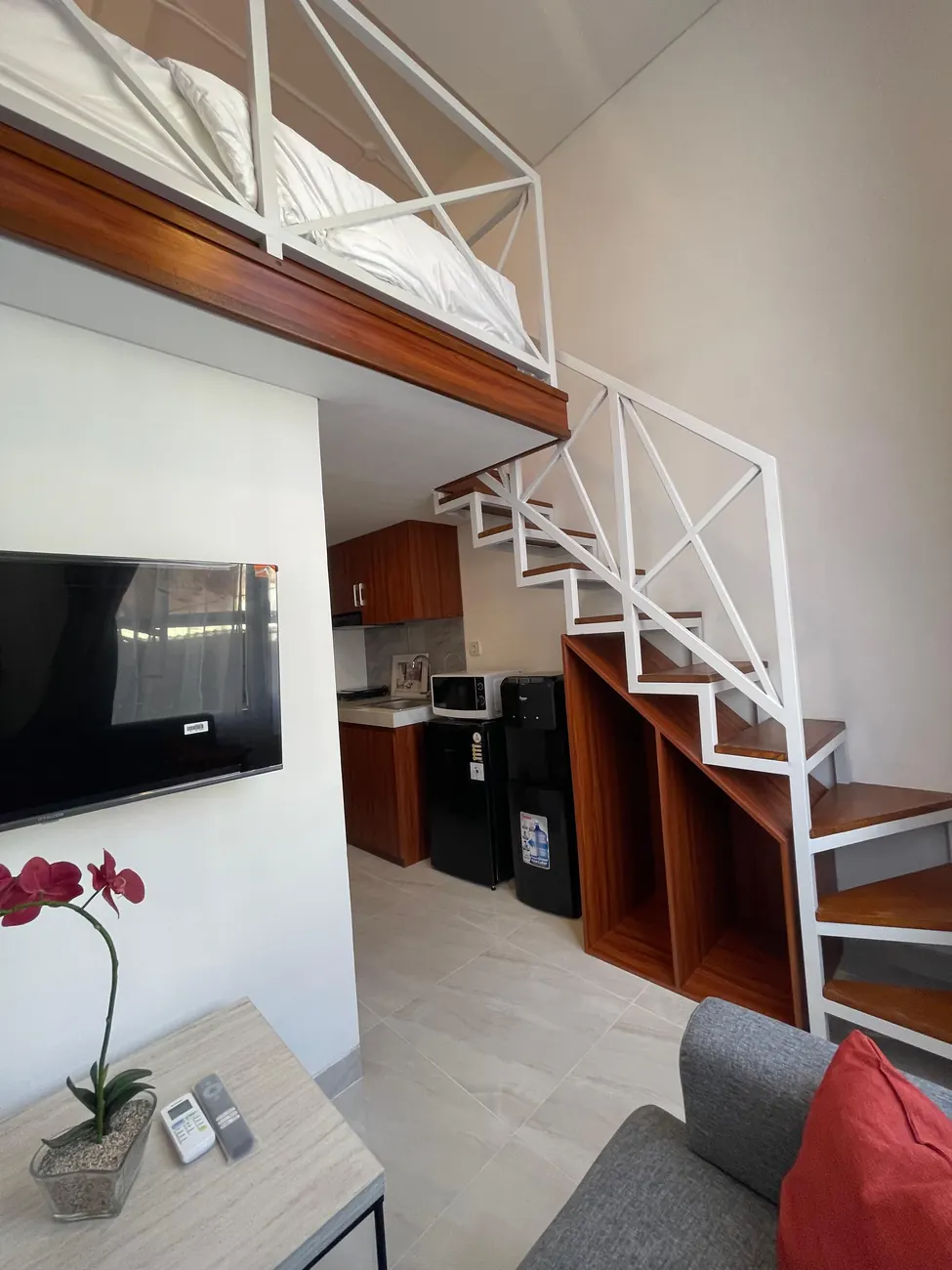 Living area with open staircase up to the loft